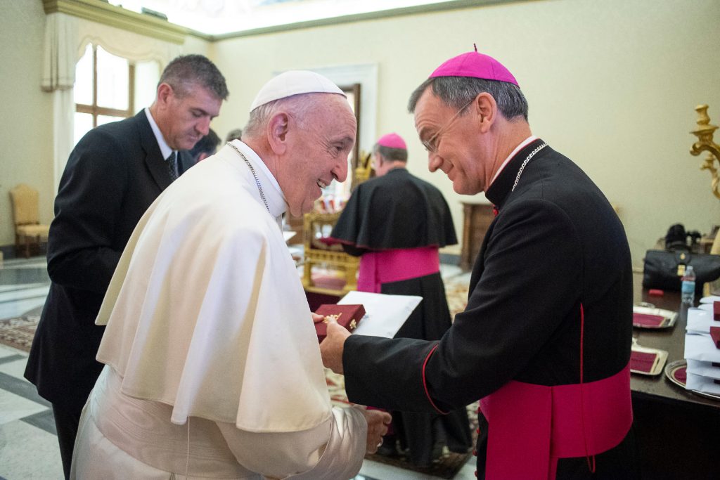 Pope Francis (left) greets Bishop John (right)