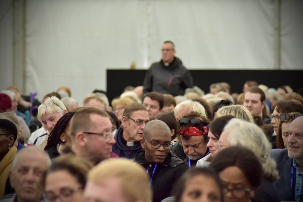 Photo depicts many people gathering together for the start of the Congress