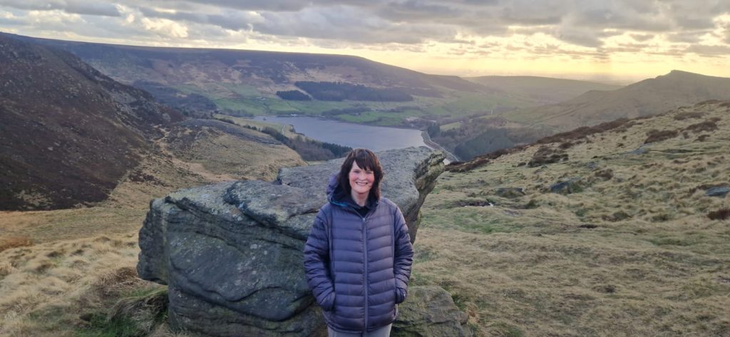 A photo of Bernie against the backdrop of hills and a reservoir