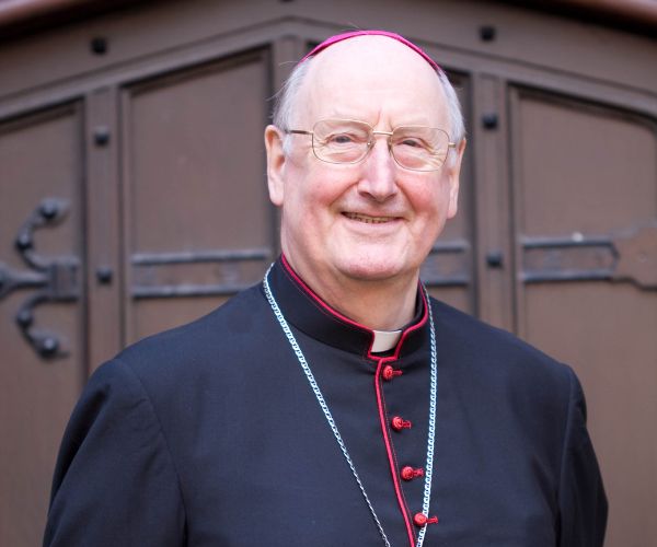 A portrait photo of Bishop Terence Brain smiling at the camera