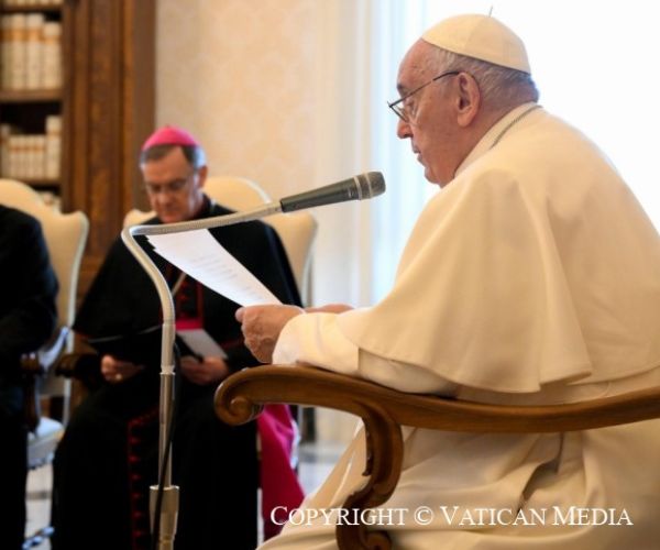 Image of Pope Francis addressing the interfaith delegation with Bishop John in shot