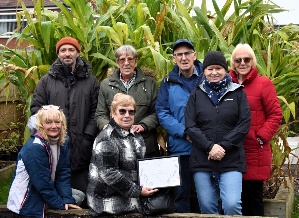 A group of the volunteers present the certificate of their North West in Bloom Award