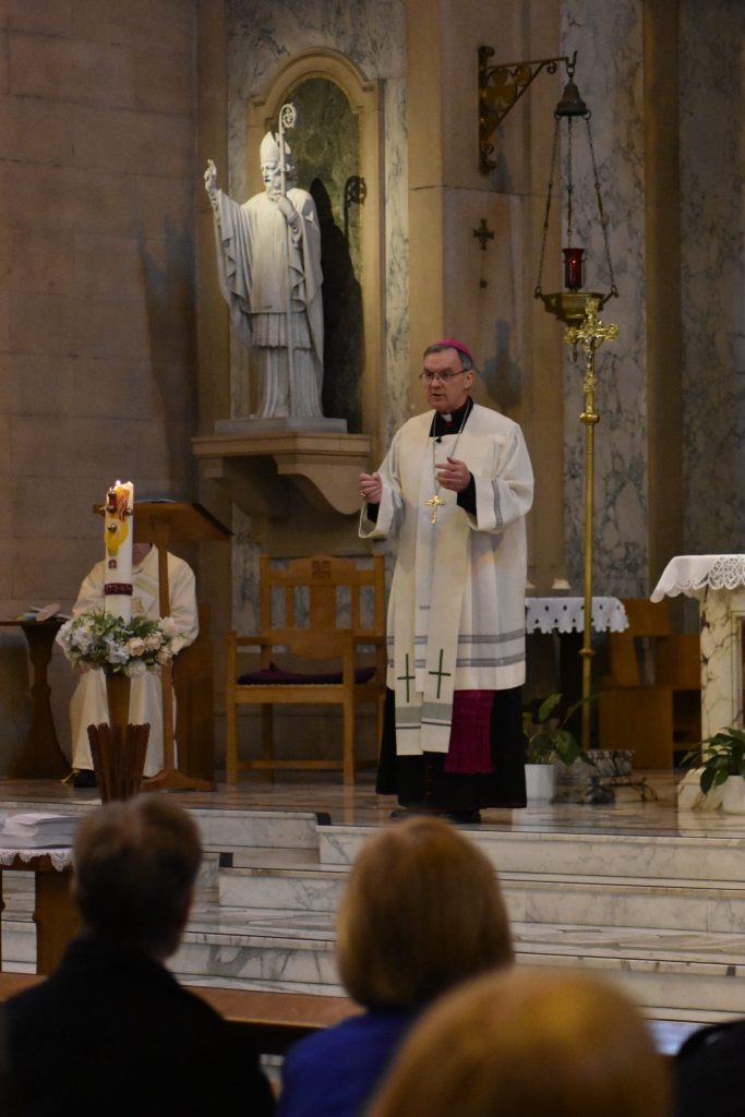 Bishop John stands on the marble Sanctuary of St Patrick's to address the congregation during the homily