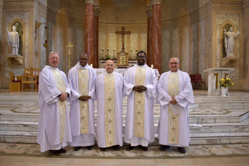Five of our second deacons stand in front of the altar