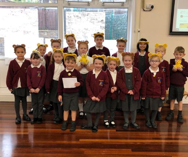 Primary school pupils from St Mary's pose in Pudsey ears, combined with their maroon and grey school uniform