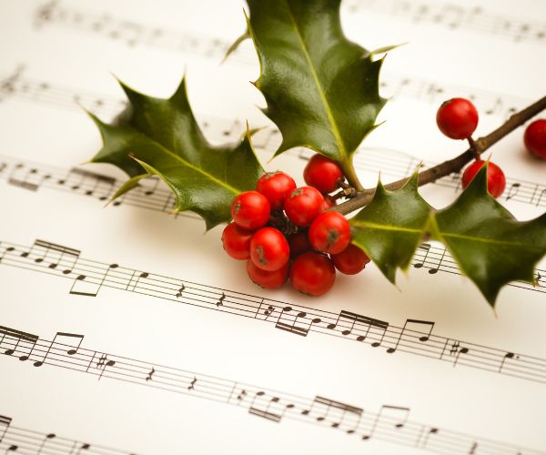 Music notation with a branch of holly